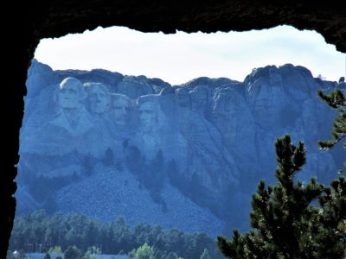 Driving Iron Road, Mt. Rushmore is framed by tunnels.
